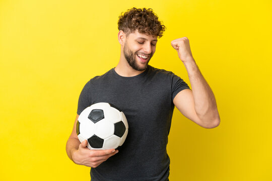 Handsome Young Football Player Man Isolated On Yellow Background Celebrating A Victory