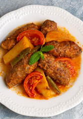 Traditional Homemade Turkish Food Kofte - Kofta with Tomato Sauce and Potatoes. (Turkish name; Izmir kofte)