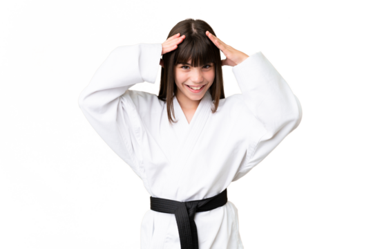 Little Caucasian girl doing karate over isolated background with surprise expression