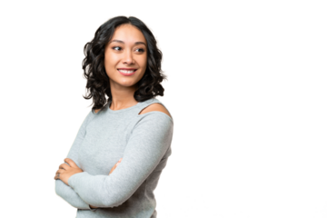 Young Argentinian woman over isolated background with arms crossed and happy