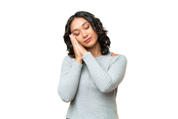 Young Argentinian woman over isolated background making sleep gesture in dorable expression