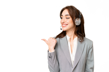 Telemarketer caucasian woman working with a headset over isolated chroma key background pointing to the side to present a product
