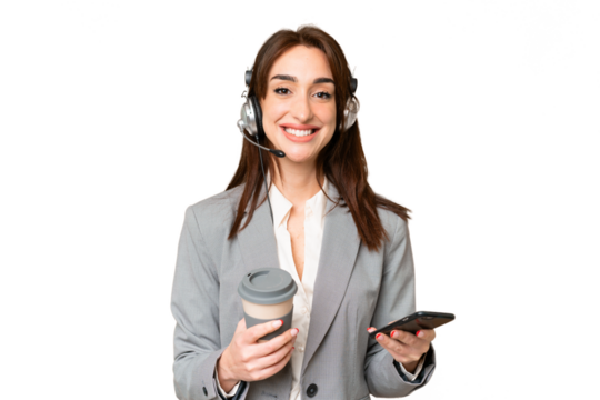 Telemarketer caucasian woman working with a headset over isolated chroma key background holding coffee to take away and a mobile