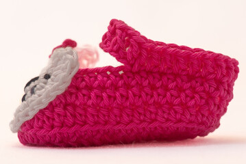 shoes with faces for a newborn, crocheted, on a white background