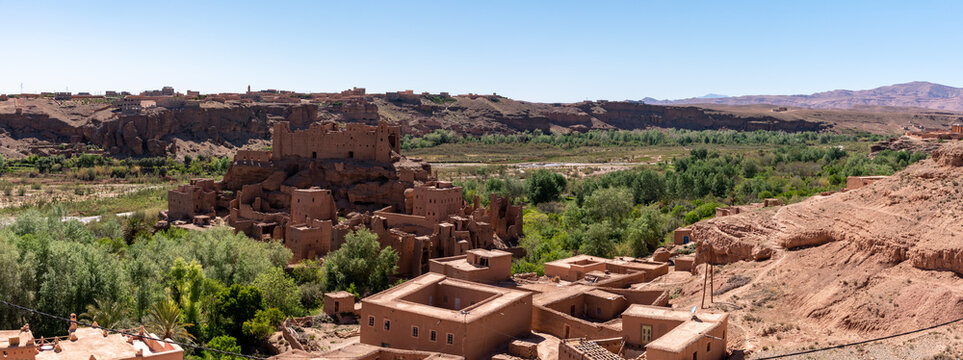 Old deserted big Kasbah on a hill surrounded by a palm grove in the valley of roses