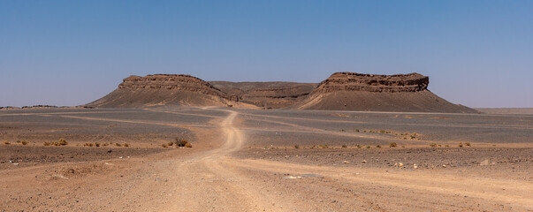 Iconic horseshoe mountain Gara Medouar in the desert near Merzouga, known for different film sets
