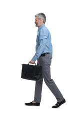 Mature businessman in stylish clothes with briefcase walking on white background