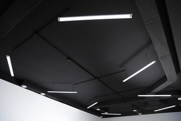 Black ceiling with modern lighting in room, low angle view - obrazy, fototapety, plakaty