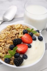 Tasty oatmeal, yogurt and fresh berries in bowl on table, closeup. Healthy breakfast