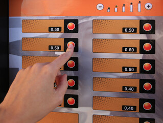 Using coffee vending machine. Woman pressing button to choose drink, closeup - obrazy, fototapety, plakaty