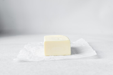 butter on parchment paper, organic block of butter, butter for baking