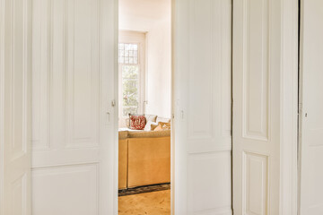 the inside of a room with two white doors and a brown rug on the floor in front of the door