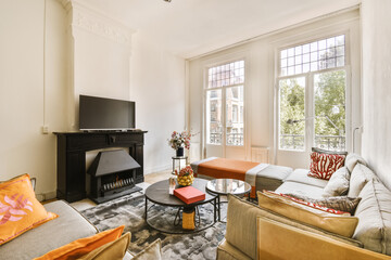 a living room with two couches and a flat screen tv in the corner of the room is very white
