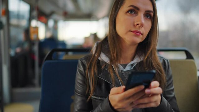 Public transport. Woman in tram using smartphone