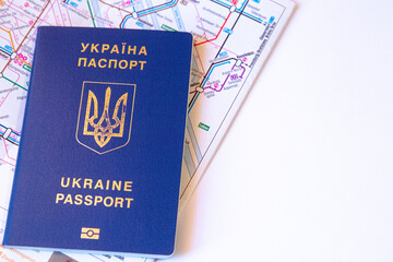 Fototapeta premium Close up view of Ukrainian passport on the map of transport in city in EU. Copy space. White background