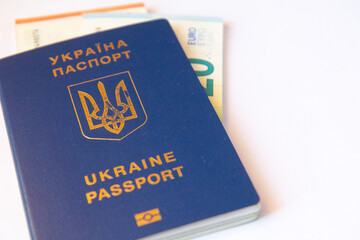 Ukrainian passport with money on white background. Copy space. Close up view
