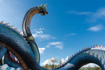 The majestic and greenish-blue colored King of Naga, the giant Thai dragon or serpent king statue...