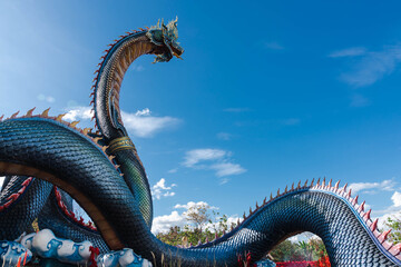 The majestic and greenish-blue colored Naga statue is 122 meters long and 20 meters high in Wat Roi...