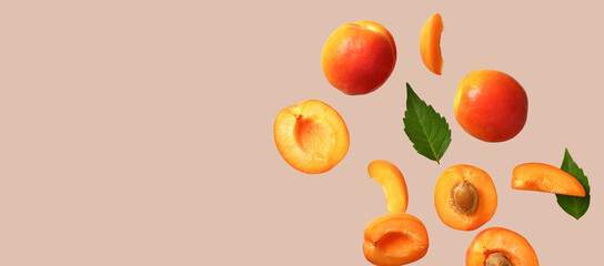 Flying fresh apricots on grey background with space for text
