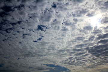 White fluffy clouds in the sky at sunset. Nature scene.