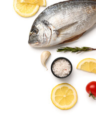 Raw dorado fish with lemon and garlic on white background