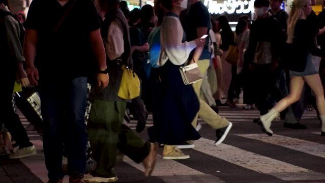 TOKYO, JAPAN : Slow Motion Shot Of Crowd Of People Walking At Shibuya Crossing At Night. Busy Crowded Downtown Area In Tokyo. Japanese People, Urban City Nightlife And Metropolis Concept Video.