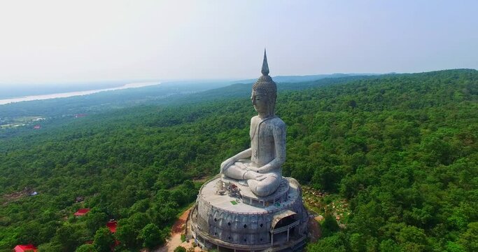 aerial view Big white buddha statue on mountain for thai people travel visit and respect .praying at Wat Roi Phra Phutthabat Phu Manorom on May 15, 2017 in Mukdahan, Thailand..Big Buddha 