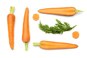 Fresh carrots and slices on orange background