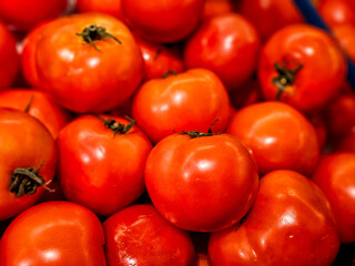Close-up Pile of red tomatoes in a supermarket local market, Bunch of organic tomatoes. Fresh ripe...