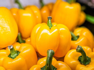 Pile of Yellow bell peppers in a supermarket local market, Bunch of organic sweet yellow peppers. Fresh ripe Yellow peppers
