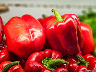 Pile of Red bell peppers in a supermarket local market, Bunch of organic red peppers. Fresh ripe red peppers