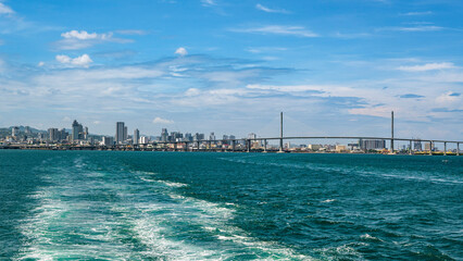 Cebu City, Philippines - April 28, 2023: Skyline of Metro Cebu and CCLEX as seen from a departing ship.