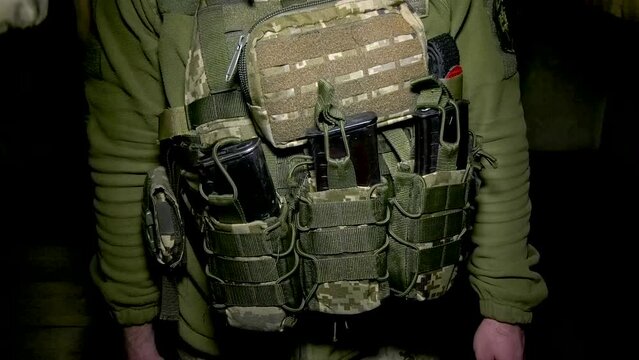 Close-up on a soldier body armor with unloading and magazines for machine gun cartridges. Equipment of a soldier of the Ukrainian army. Russian-Ukrainian War 2022-2023