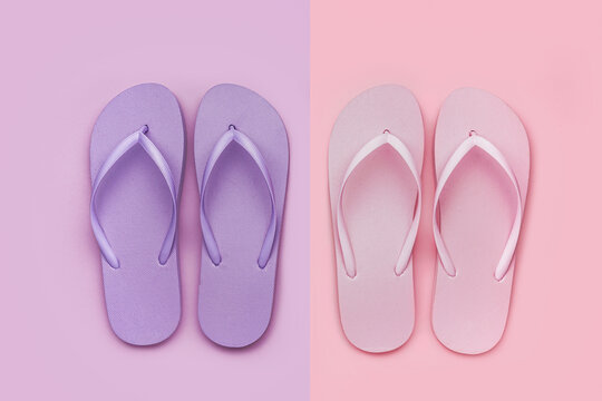 Pink and lilac flip-flops on color background
