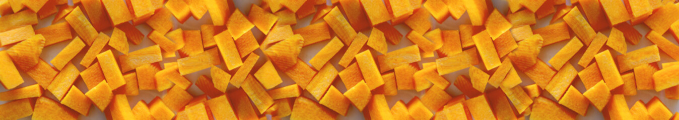 carrot cut into cubes close-up. A set of vitamins. Vegan food. Healthy food. Horizontal image....