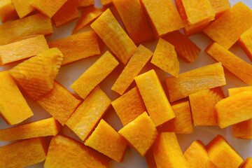 carrot cut into cubes close-up. A set of vitamins. Vegan food. Healthy food. Horizontal image.