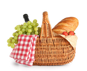 Wicker basket with delicious food for picnic on white background