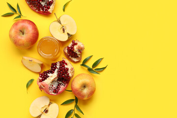Composition with ripe fruits and honey on yellow background. Rosh hashanah (Jewish New Year) celebration