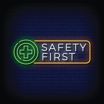 Neon Sign safety first with brick wall background vector