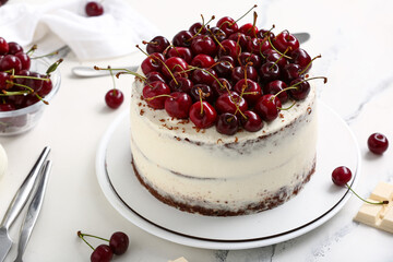 Plate with tasty cherry cake on white marble background