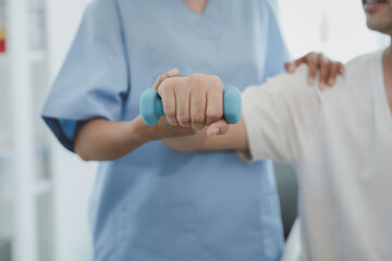 A professional physiotherapist is doing stretching for a patient, the patient has muscle...