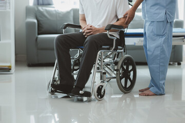 Fototapeta na wymiar Male patient sitting in wheelchair undergoing a medical examination with specialist physician, treating injuries Getting medical treatment from specialist doctor can get the right and proper treatment