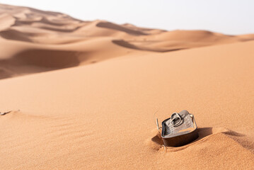 Fototapeta na wymiar A fish tin left behind, polluting the Sahara desert