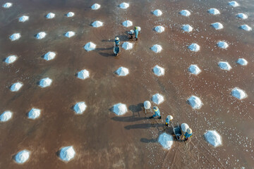 Field and Sea salt pile pyramid ready for harvest in salt farm. Sea salt is salt that is produced...