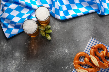 Flag of Bavaria, mugs with beer and pretzels on grey background