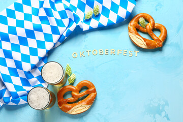 Word OKTOBERFEST, flag of Bavaria, mugs with beer and pretzels on blue background