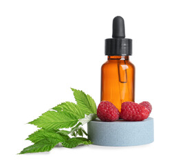 Decorative podium with bottle of cosmetic raspberry oil on white background