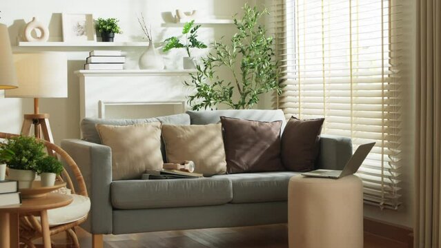 home interior design detail of Modern clean living room with soft and cosy sunlight pillow upholstery cushion arrange on white sofa dolly shot close up,home sweet home background