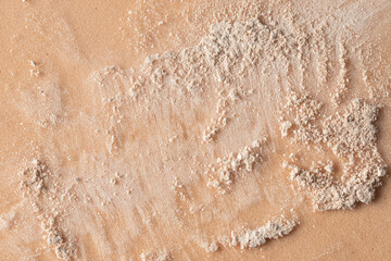 Light beige crushed powder texture on beige backgroudn for cosmetic background. Abstract image