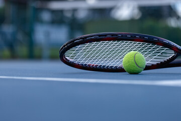 Close up of tennis ball and tennis racket on tennis court